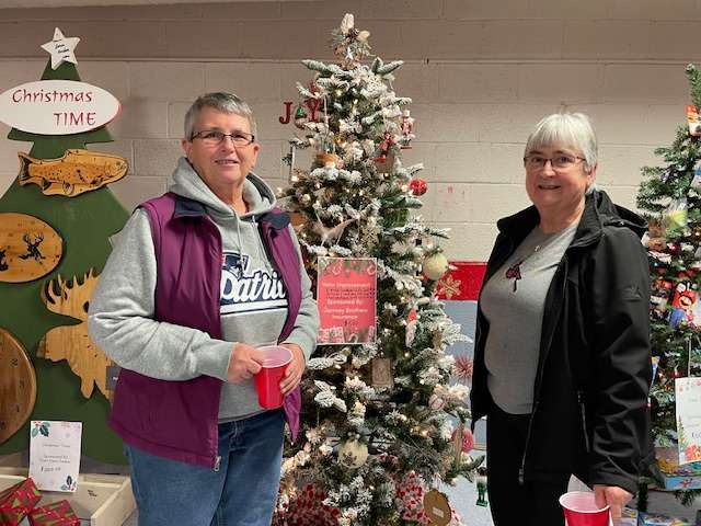 L-R: Deb Lawrence and Elaine Beaurivage, enjoying this Garnsey Brothers Tree. 
