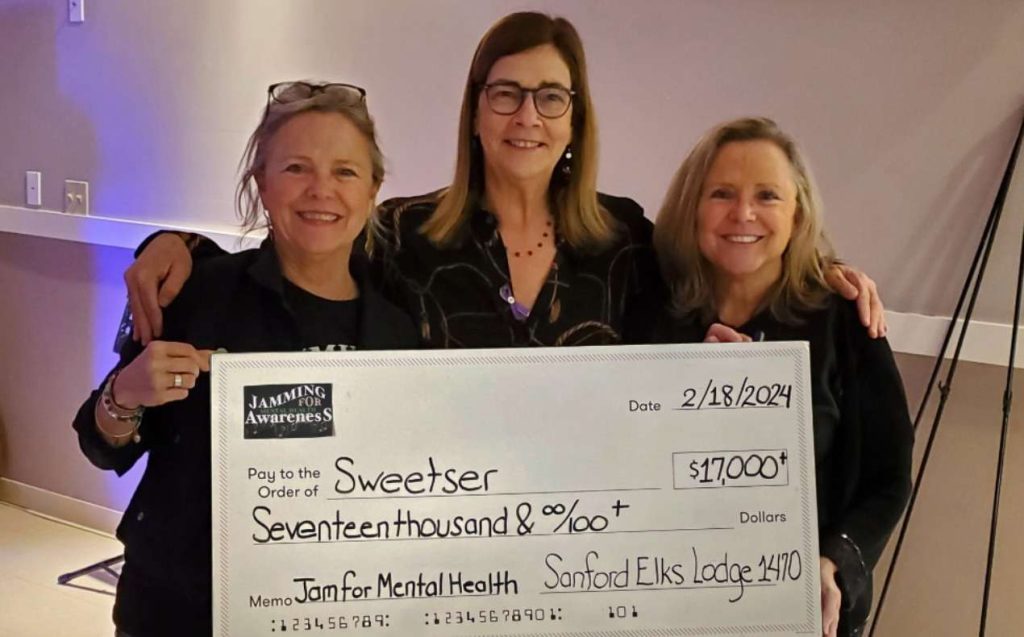 Denise Labbe (left) and Marise Anagnost (center) present a check to Sweetser President/CEO Jayne Van Bramer