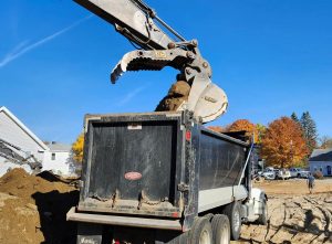 excavator loads a dump truck